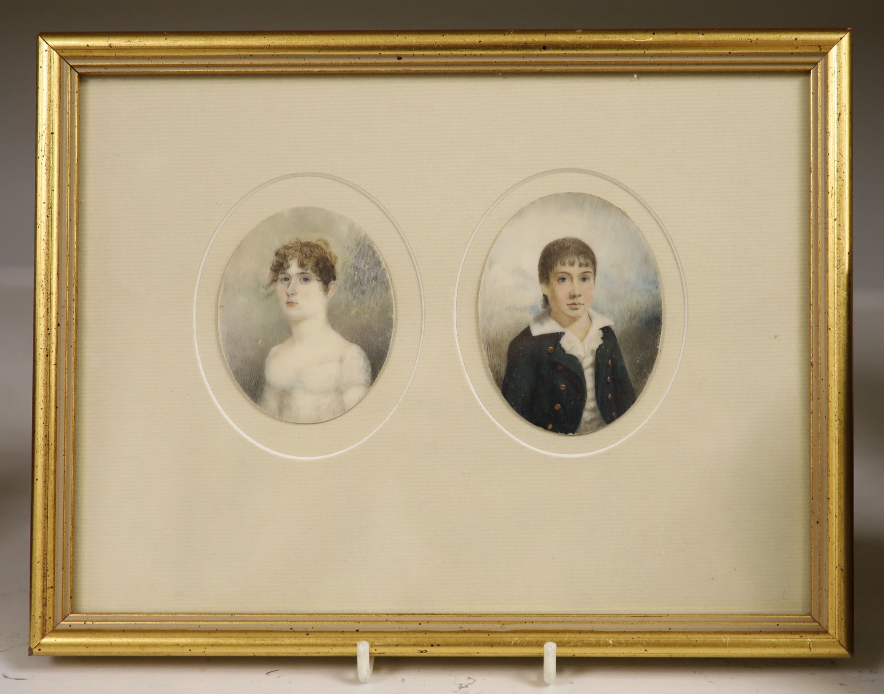 Early 19th century English School, pair of oil on ivory miniatures, Portraits of a youth and young woman, 7 x 5.5cm, framed as one